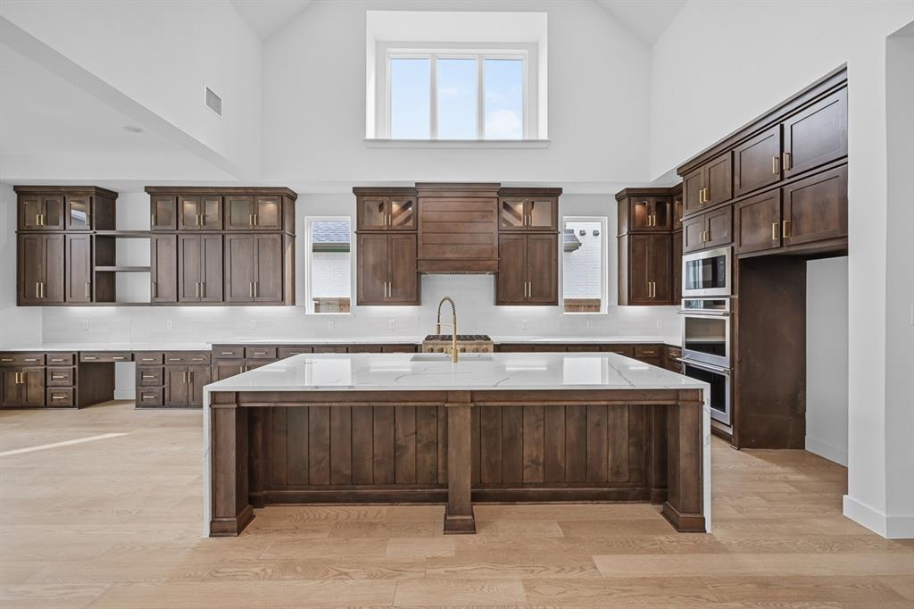 571 Twilight Drive Prosper, TX 75078 - Photo 3 of 30 a view of a kitchen with stainless steel appliances granite countertop a stove and a sink