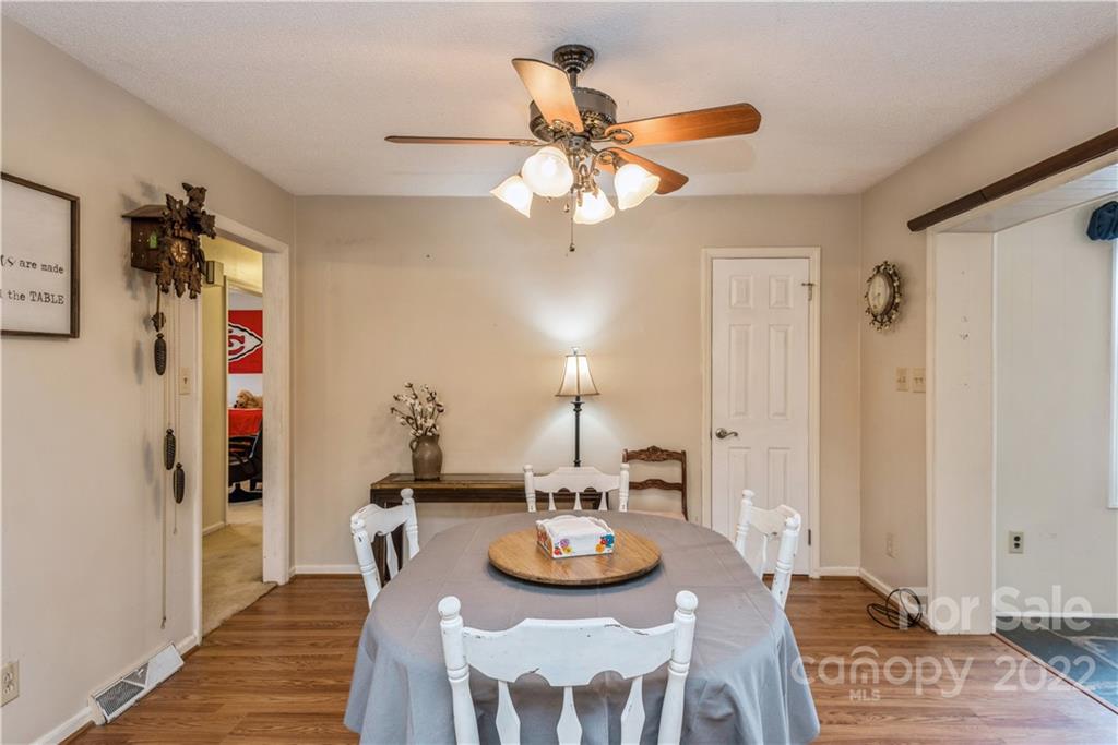 4600 Stallings Road Matthews, NC 28105 - Photo 17 of 38 a view of a dining room with furniture and wooden floor
