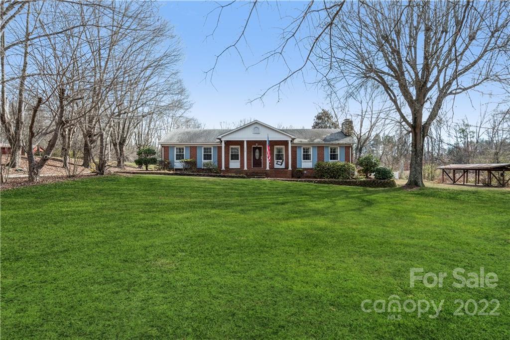 4600 Stallings Road Matthews, NC 28105 - Photo 2 of 38 a front view of residential houses with yard and trees