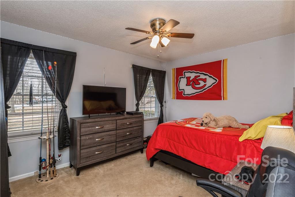 4600 Stallings Road Matthews, NC 28105 - Photo 23 of 38 a bedroom with a bed and a flat screen tv