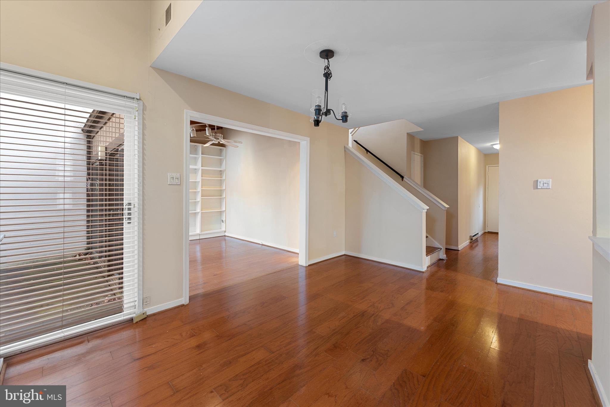 2337 Glade Bank Way Reston, VA 20191 - Photo 17 of 50 a view of a livingroom with wooden floor and a ceiling fan