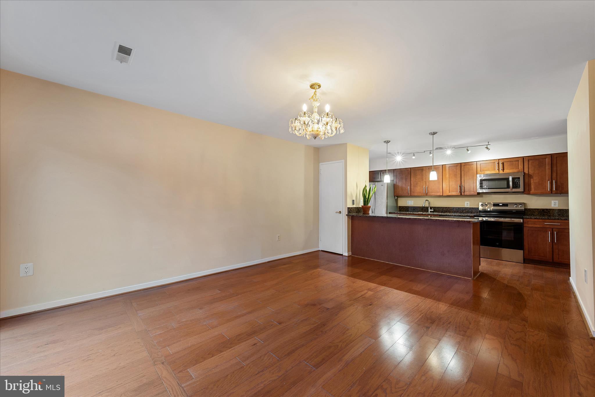 2337 Glade Bank Way Reston, VA 20191 - Photo 9 of 50 a view of kitchen with kitchen island wooden floor and stainless steel appliances