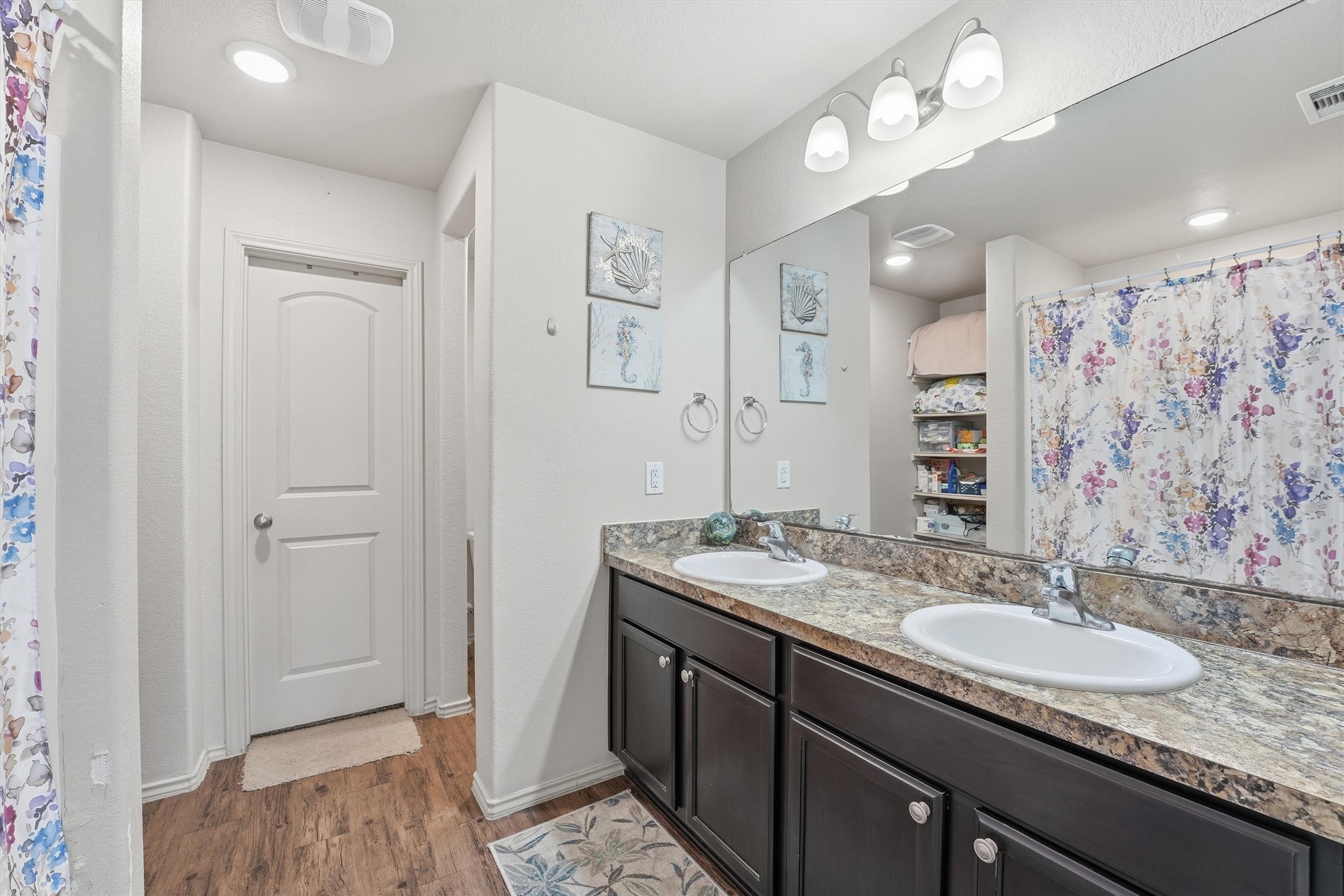 15455 Rancho Joya Way Houston, TX 77049 - Photo 14 of 20 a bathroom with a granite countertop sink a mirror and a shower