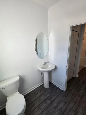 a bathroom with a sink toilet and a mirror