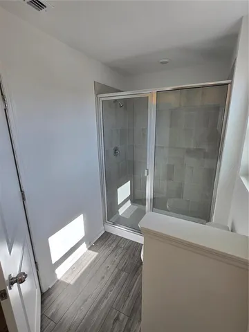 a bathroom with a toilet and a shower