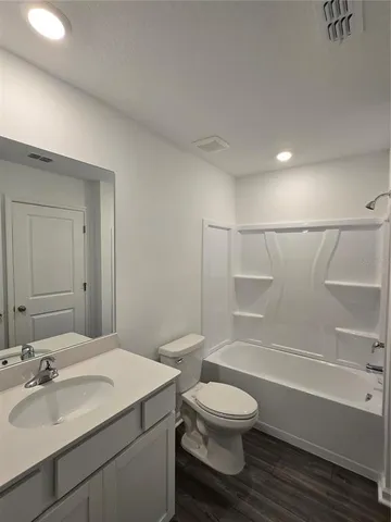 a bathroom with a toilet and a bathtub