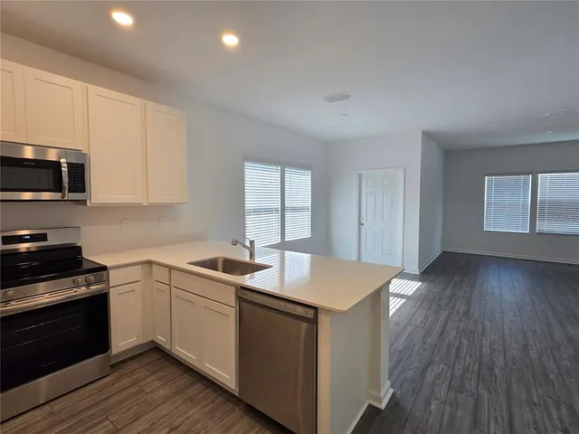 a kitchen with a sink and cabinets