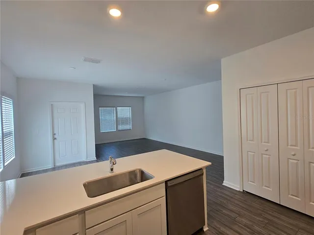 a view of a room with wooden floor and a hallway