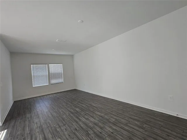 a view of an empty room and wooden floor