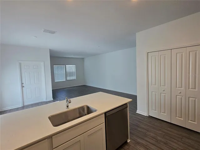 a room with a sink and cabinets