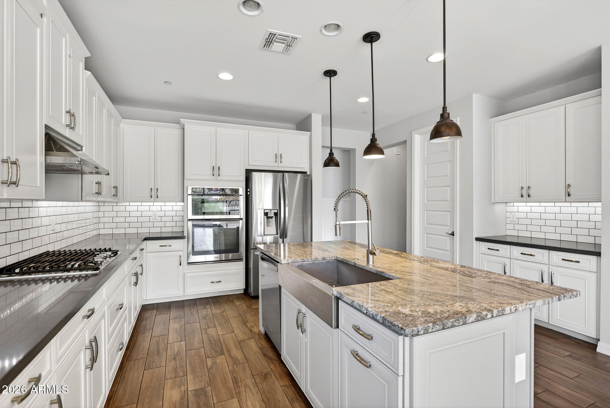 12124 West Peak View Road Peoria, AZ 85383 - Photo 4 of 38 a kitchen with stainless steel appliances granite countertop a sink stove and refrigerator