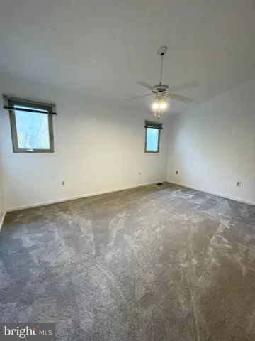 a view of a room with a ceiling fan