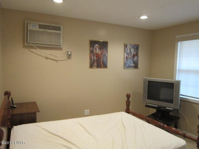 203 Westcolang Road Lackawaxen, PA 18435 - Photo 15 of 15 a bedroom with a bed and a tv