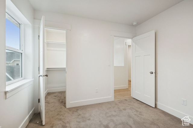 1615 North Angel Street, Unit E Layton, UT 84041 - Photo 29 of 42 Unfurnished bedroom featuring a spacious closet and light colored carpet