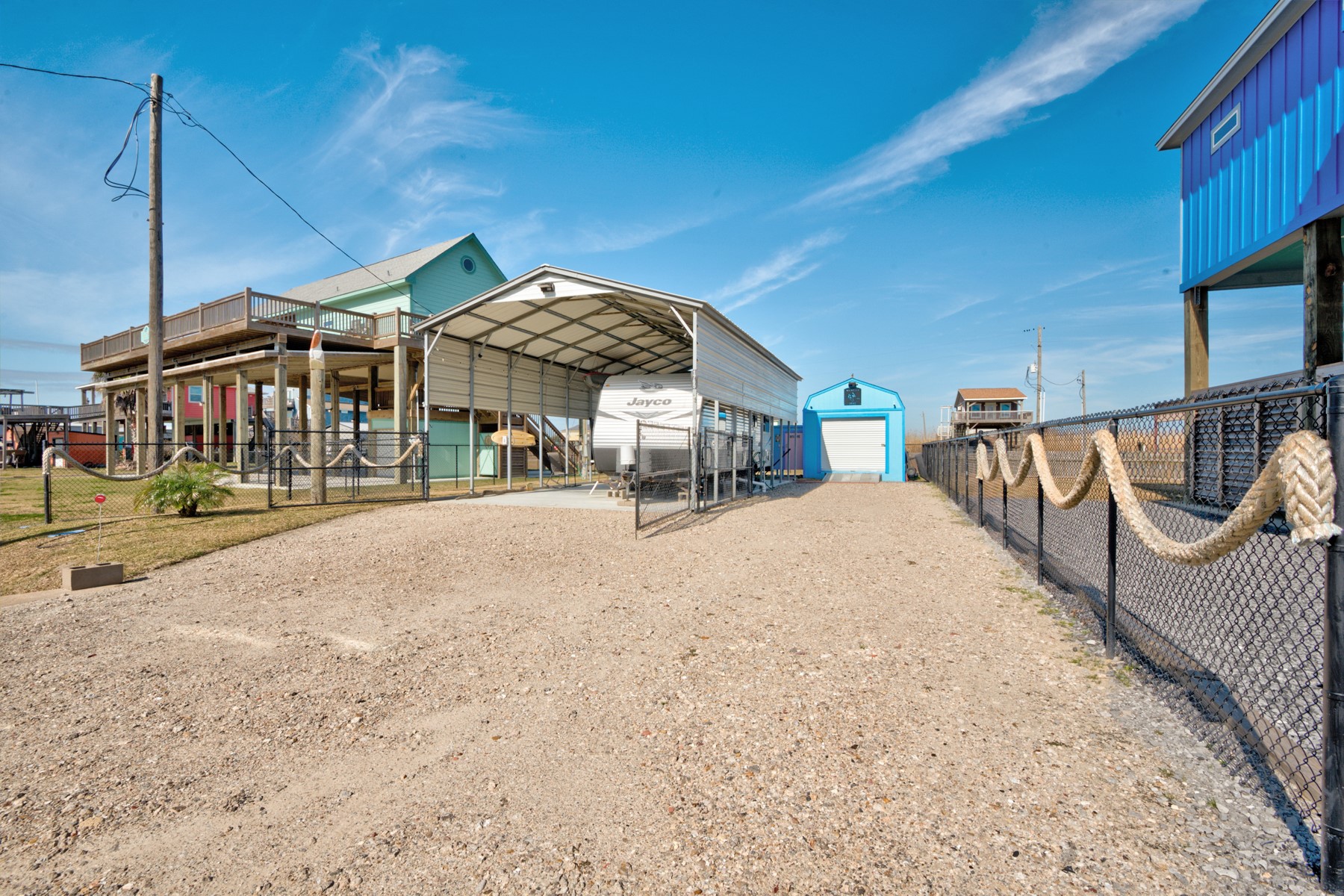 1765 Croaker Lane Crystal Beach, TX 77650 - Photo 12 of 17 a wooden bench sitting in front of a building