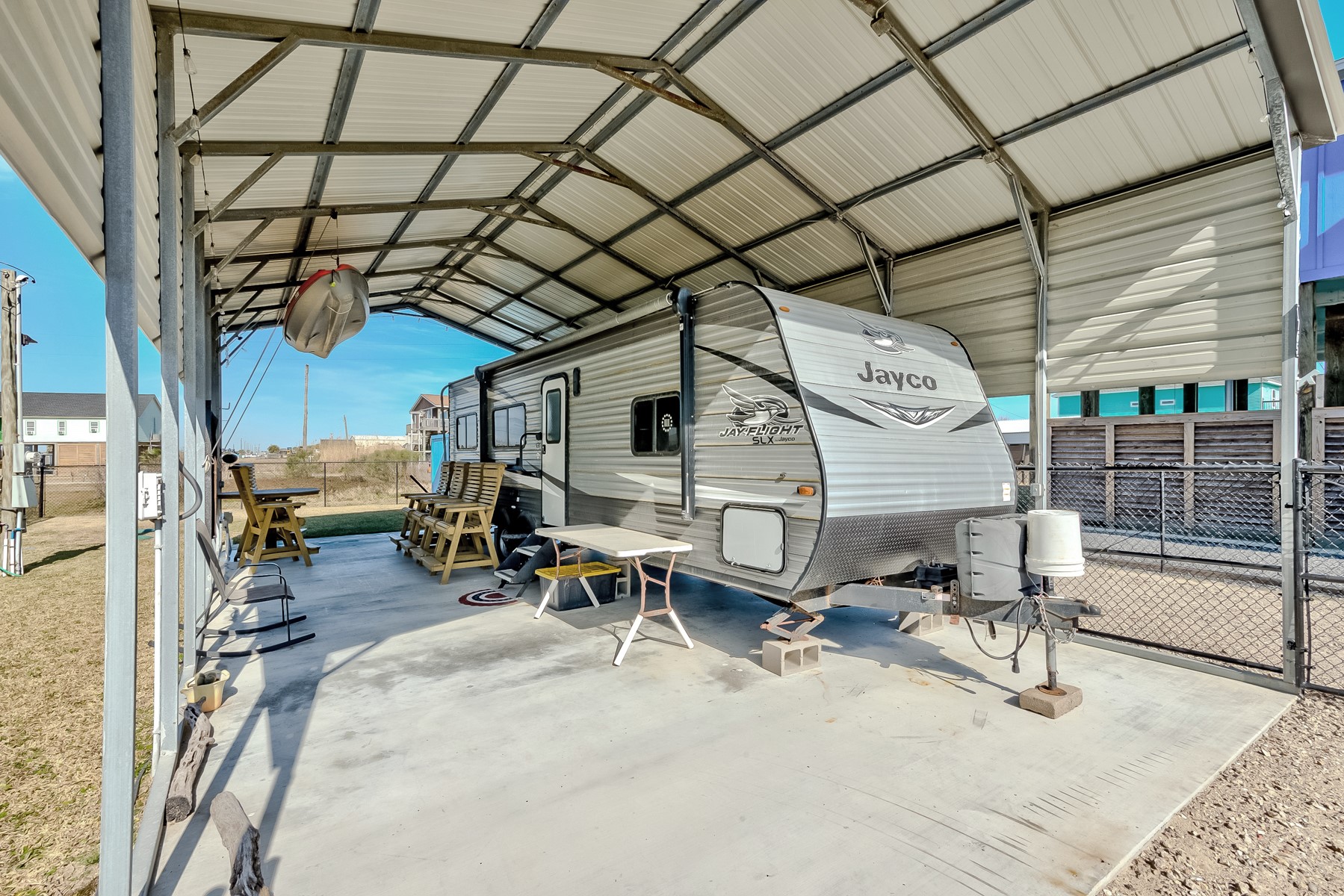 1765 Croaker Lane Crystal Beach, TX 77650 - Photo 7 of 17 a view of a chairs and table in the back yard of the house