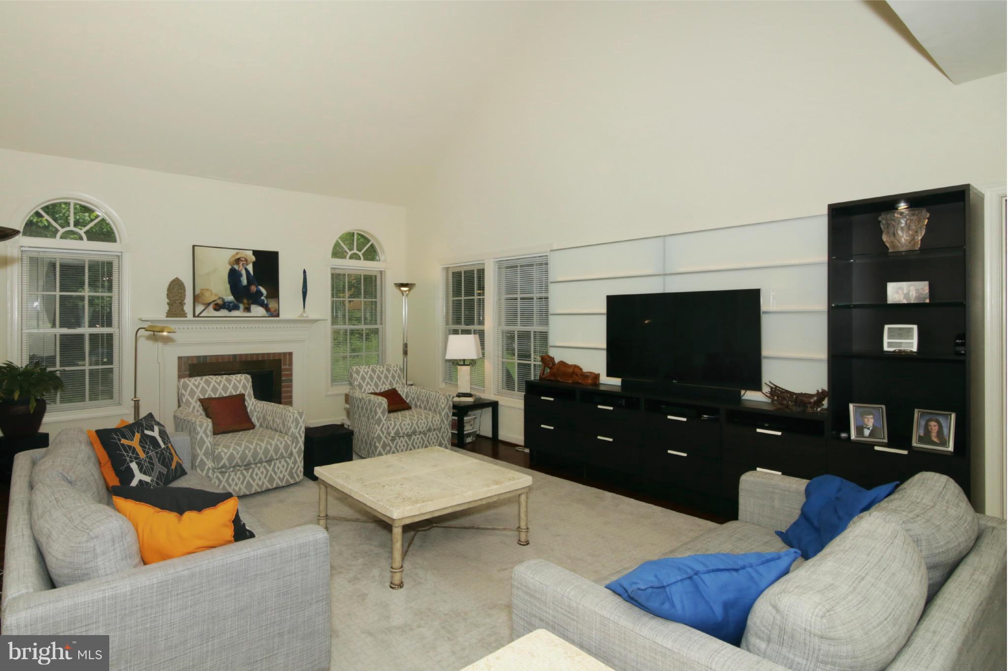 5483 Ashleigh Road Fairfax, VA 22030 - Photo 12 of 30 a living room with furniture a flat screen tv and a fireplace