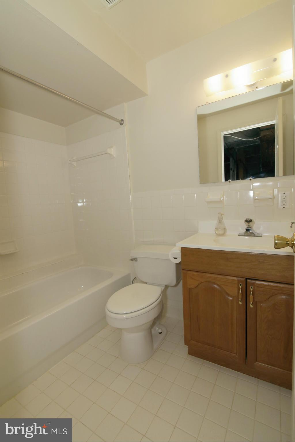 5483 Ashleigh Road Fairfax, VA 22030 - Photo 26 of 30 a bathroom with a sink a toilet and bathtub