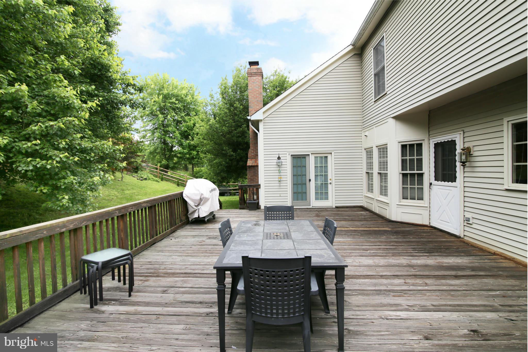 5483 Ashleigh Road Fairfax, VA 22030 - Photo 29 of 30 a view of deck with a table and chairs and wooden floor