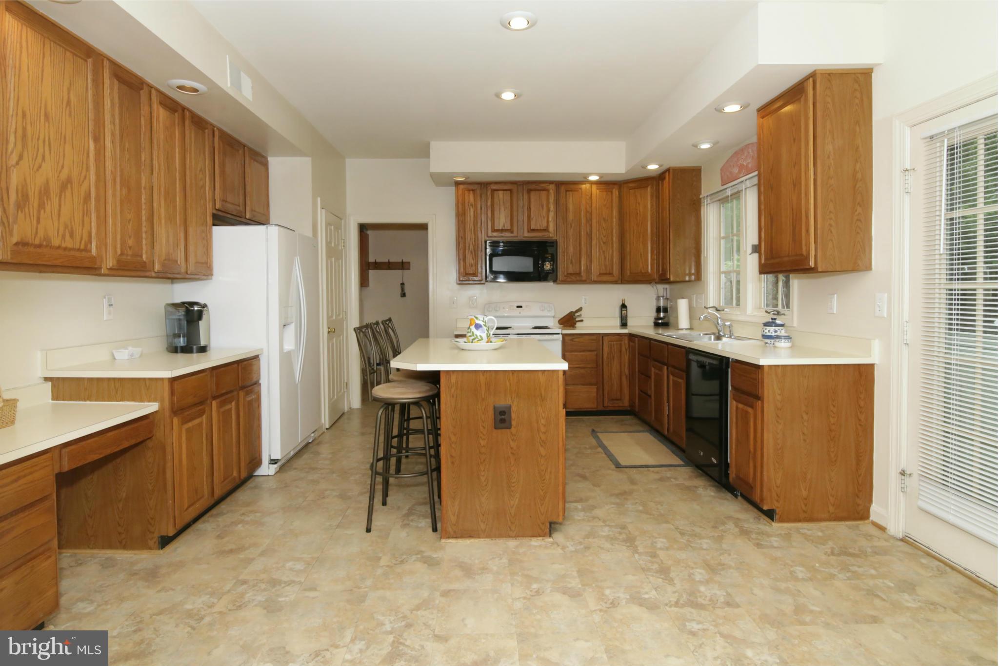 5483 Ashleigh Road Fairfax, VA 22030 - Photo 6 of 30 a kitchen with kitchen island a sink stainless steel appliances and cabinets