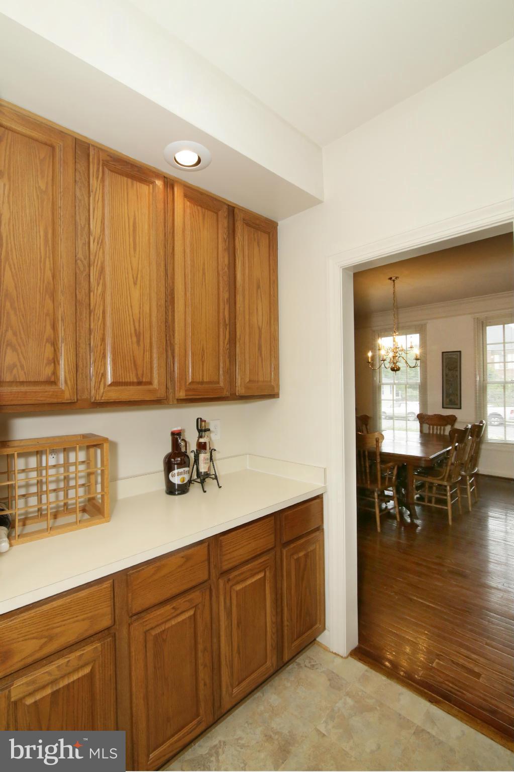 5483 Ashleigh Road Fairfax, VA 22030 - Photo 10 of 30 a kitchen with stainless steel appliances granite countertop wooden cabinets a dining table and chairs