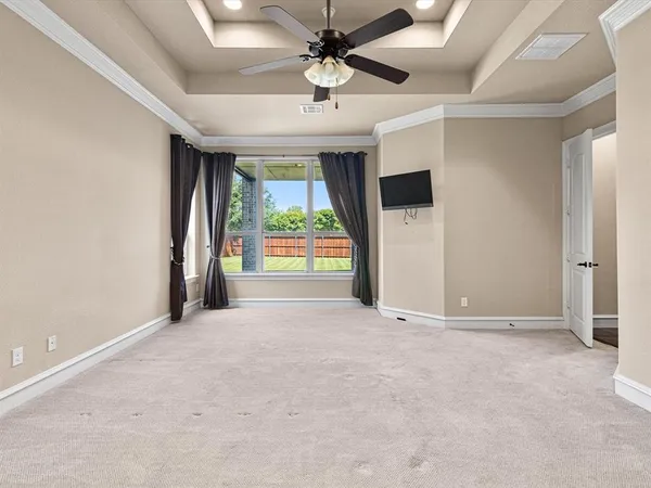 en empty room with windows and ceiling fan