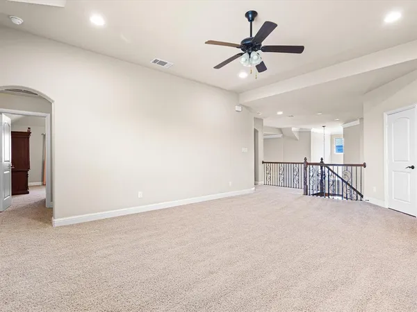 a view of an empty room and a ceiling fan
