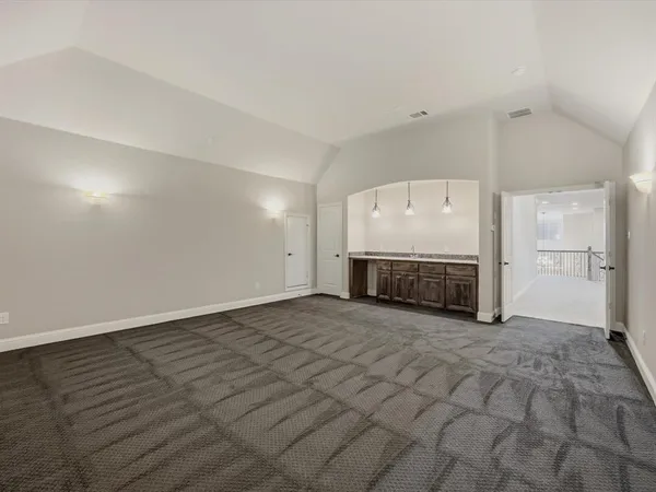 an empty room with a fireplace and cabinet