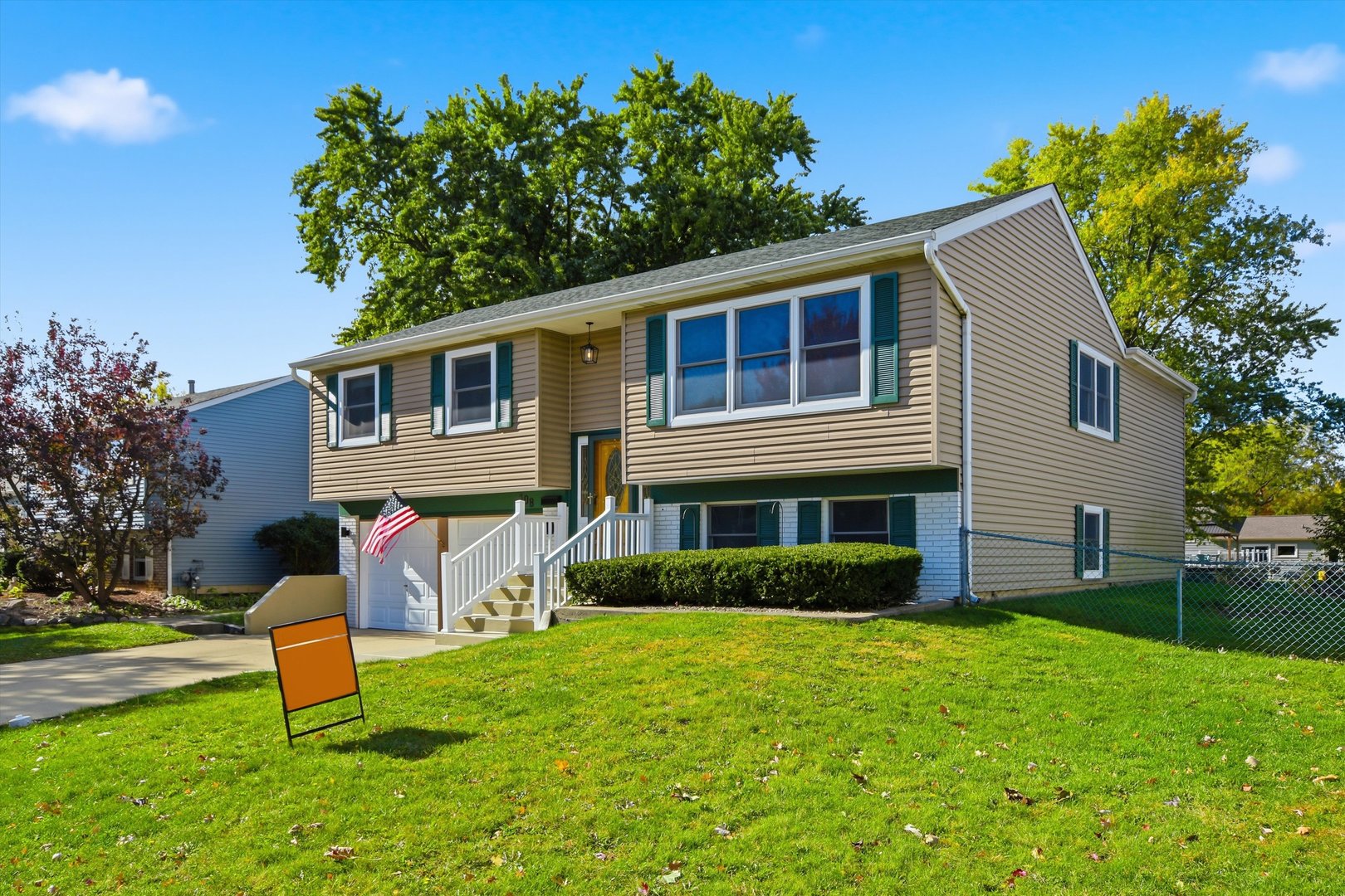 a front view of a house with garden and porch