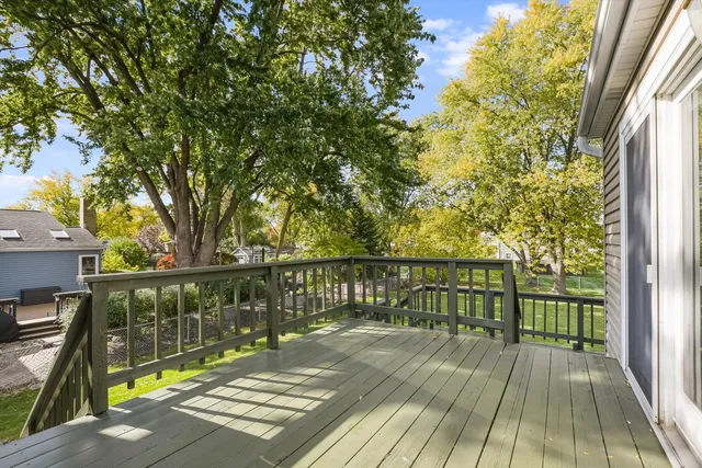 a view of balcony with wooden floor and outdoor seating