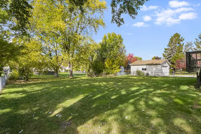 a view of a field of grass and trees