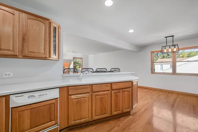 a kitchen with wooden cabinets and sink