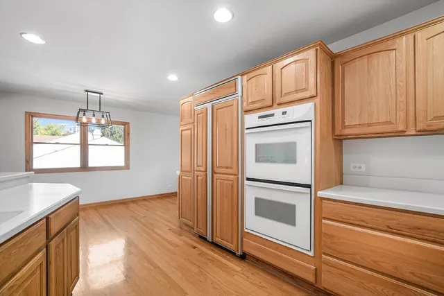 a kitchen with stainless steel appliances granite countertop a refrigerator and a stove