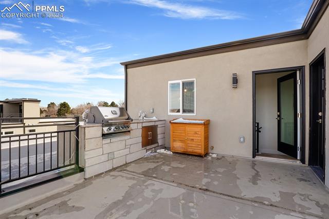 74 Sommerlyn Road Colorado Springs, CO 80906 - Photo 31 of 32 View of patio / terrace featuring exterior kitchen and grilling area