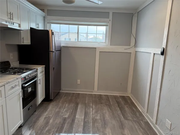 a kitchen with a refrigerator and a stove