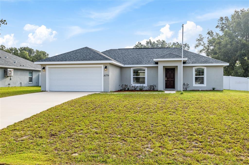 16779 Southwest 17th Avenue Ocala, FL 34473 - Photo 1 of 34 a front view of a house with a garden