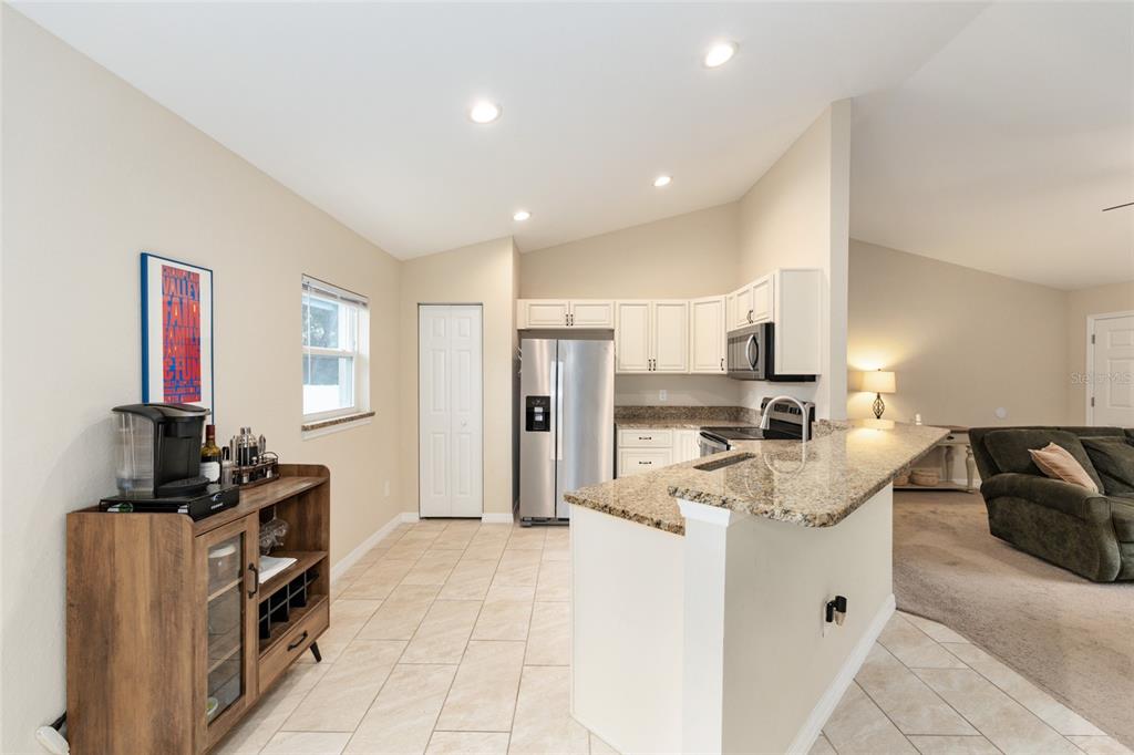 16779 Southwest 17th Avenue Ocala, FL 34473 - Photo 11 of 34 a kitchen that has a lot of cabinets a sink and a refrigerator