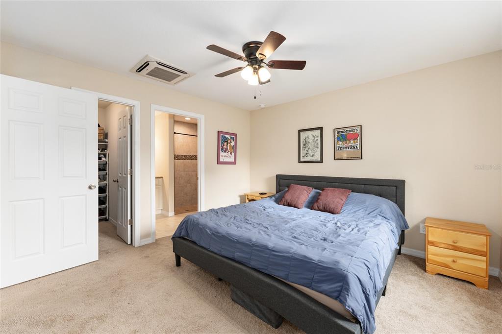 16779 Southwest 17th Avenue Ocala, FL 34473 - Photo 14 of 34 a bedroom with a bed and a ceiling fan