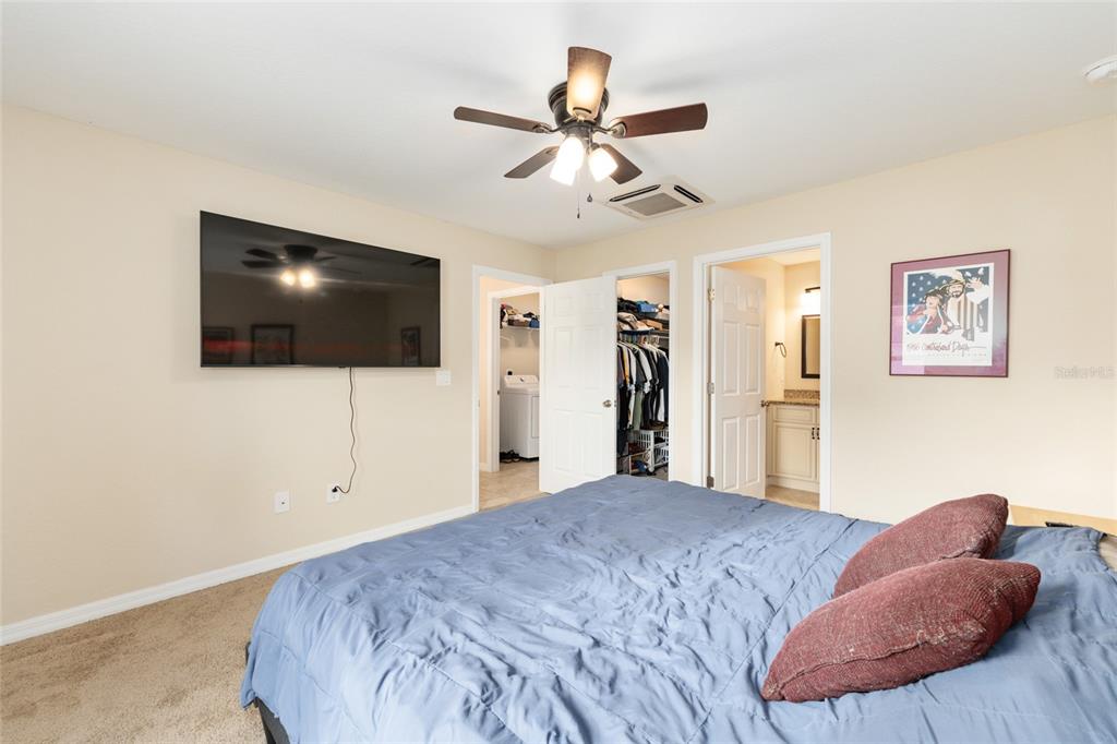 16779 Southwest 17th Avenue Ocala, FL 34473 - Photo 15 of 34 a bedroom with a bed and a flat screen tv