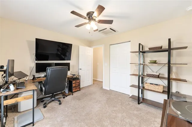 a view of a livingroom with workspace and a window