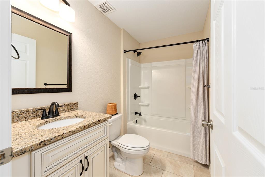 16779 Southwest 17th Avenue Ocala, FL 34473 - Photo 20 of 34 a bathroom with a granite countertop sink toilet and shower