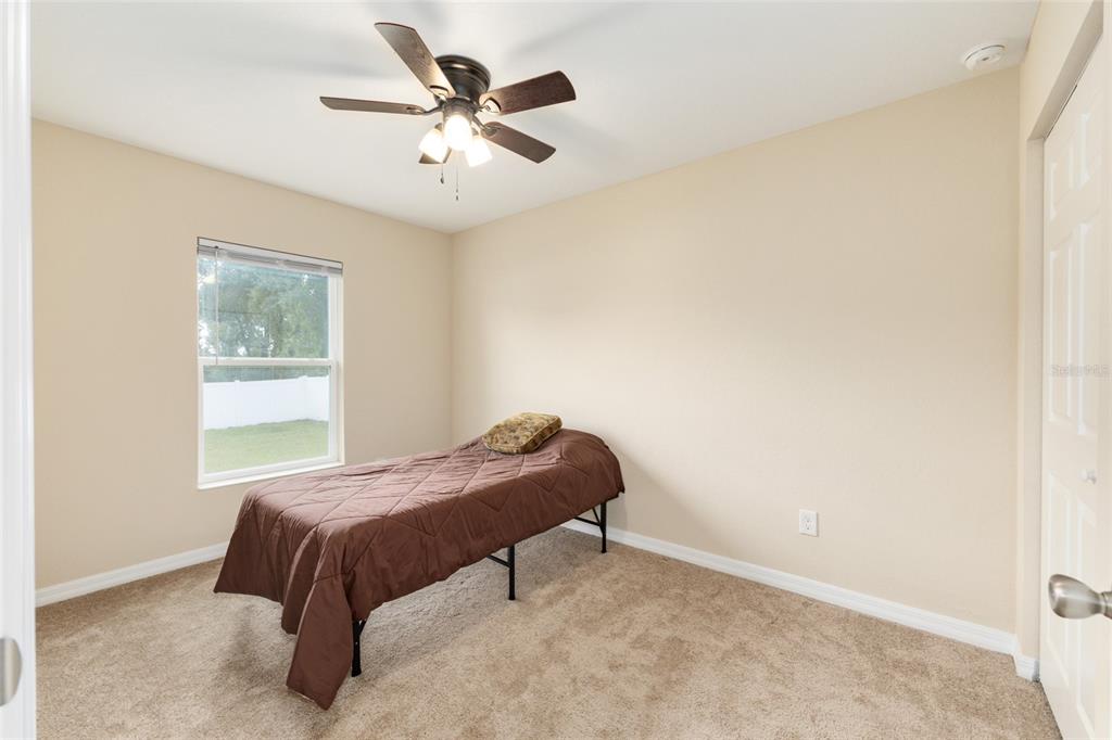 16779 Southwest 17th Avenue Ocala, FL 34473 - Photo 21 of 34 a bedroom with a bed and a window