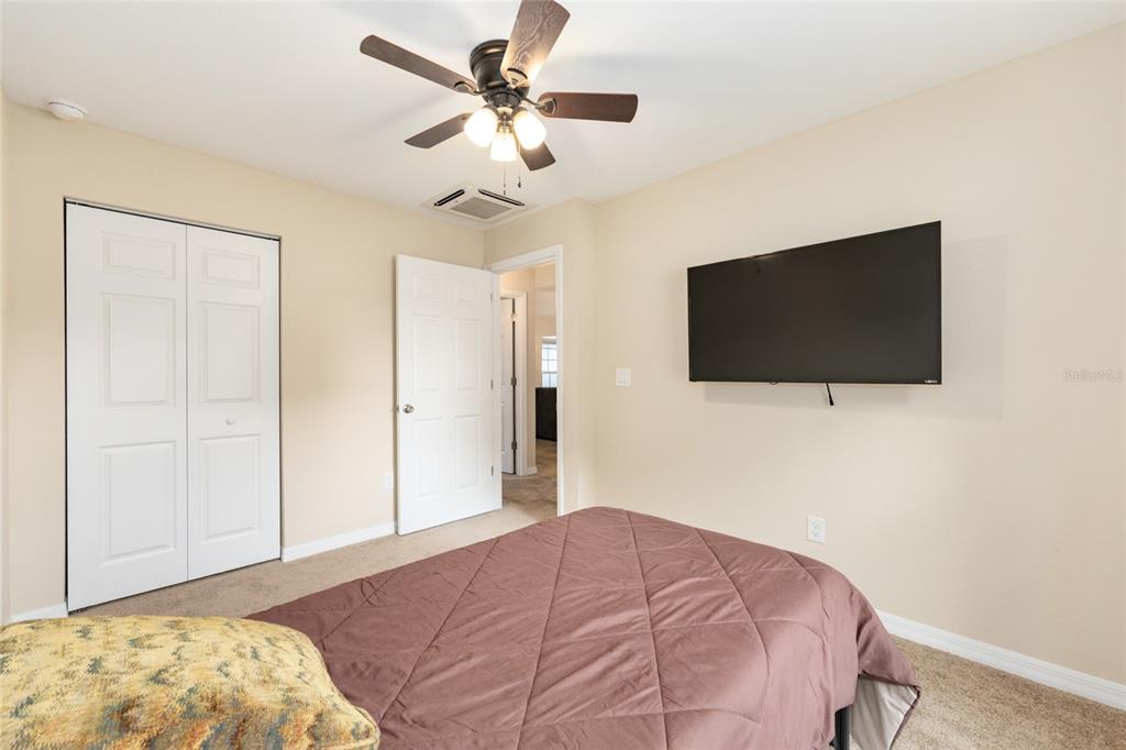 16779 Southwest 17th Avenue Ocala, FL 34473 - Photo 22 of 34 a bedroom with a bed and a flat screen tv