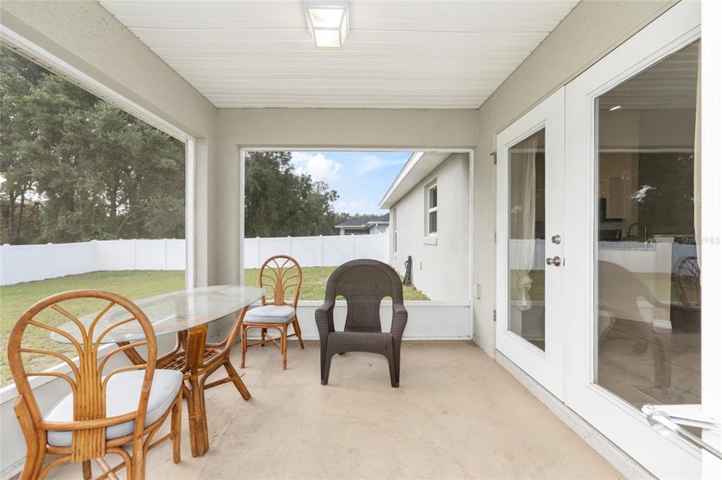16779 Southwest 17th Avenue Ocala, FL 34473 - Photo 26 of 34 a dining room with furniture and a floor to ceiling window