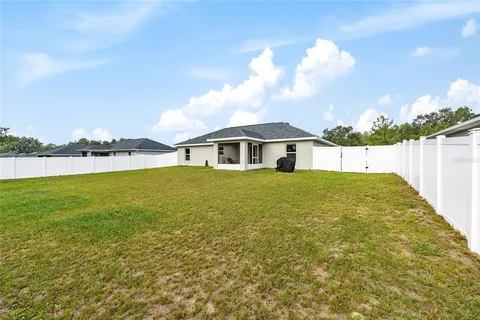 a view of house with garden and lake view