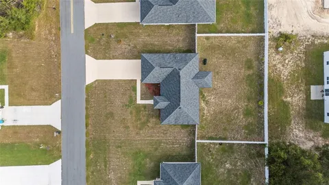 an aerial view of houses with yard