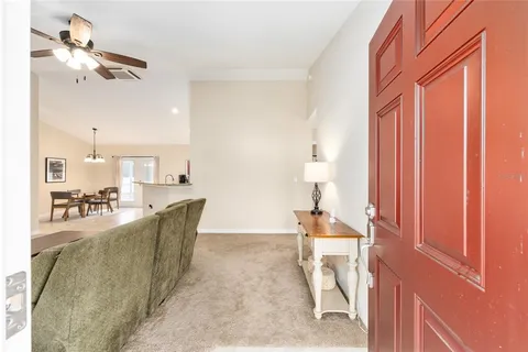 a living room with furniture a rug and white walls