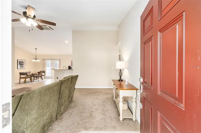 a living room with furniture a rug and white walls