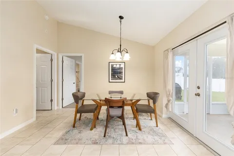 a dining room with furniture and window