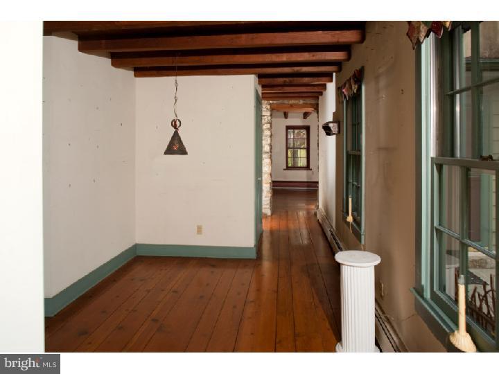 3050 Cooks Creek Road Riegelsville, PA 18077 - Photo 13 of 25 a view of a hallway with wooden floor and stairs